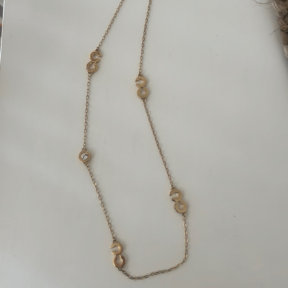 Long gold Coach necklace